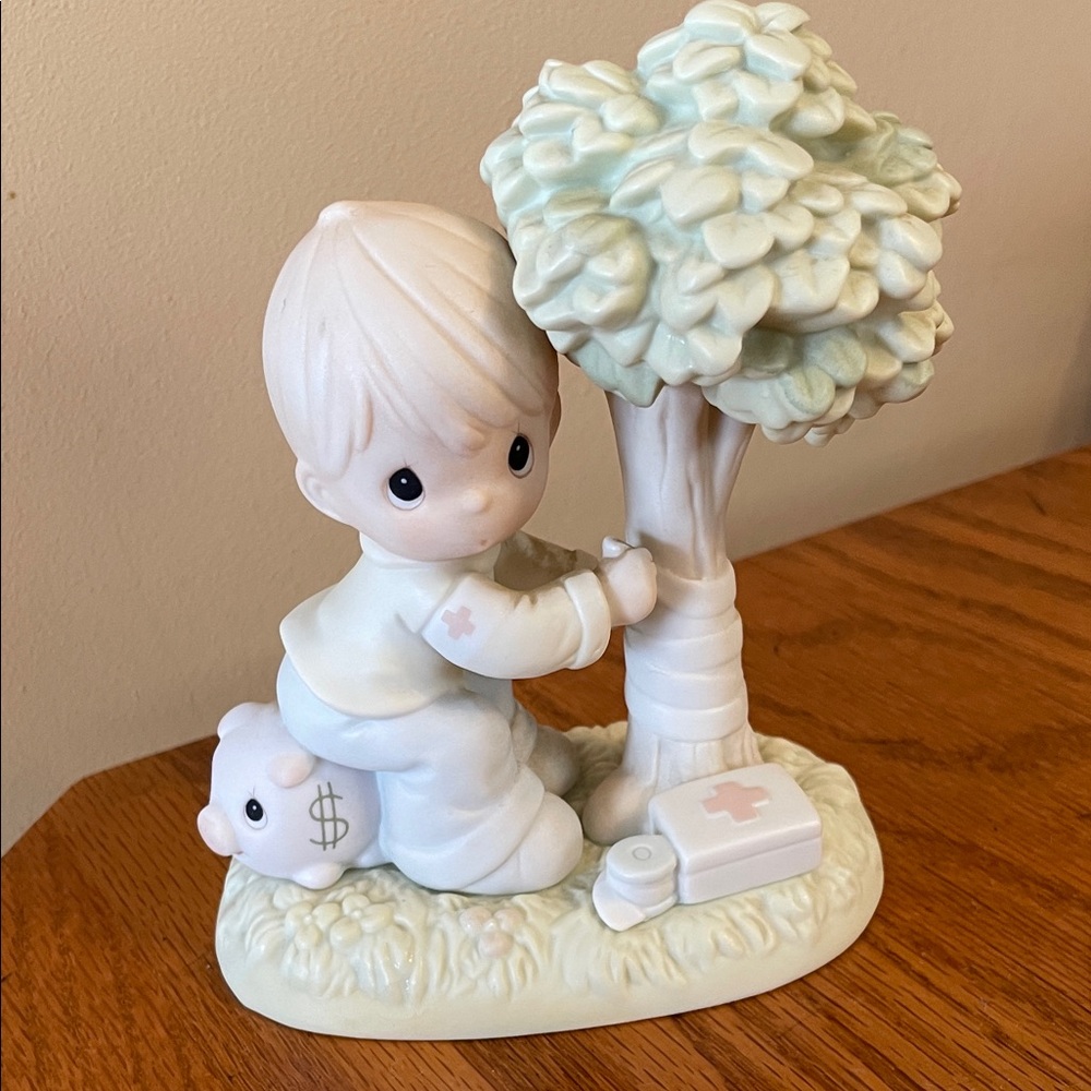 Precious Moments Figurine “Money’s Not the Only Green Thing Worth Saving”